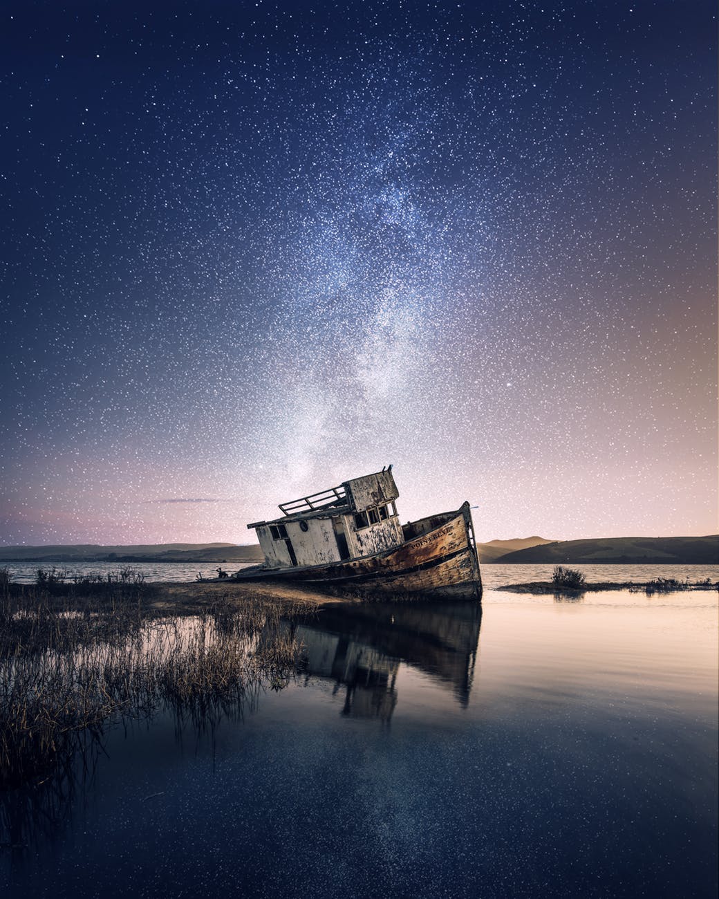 abandoned beach boat clouds